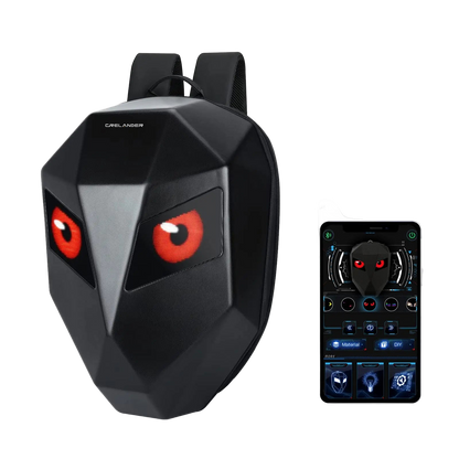 Black backpack with red eyes and a remote control device on a white background