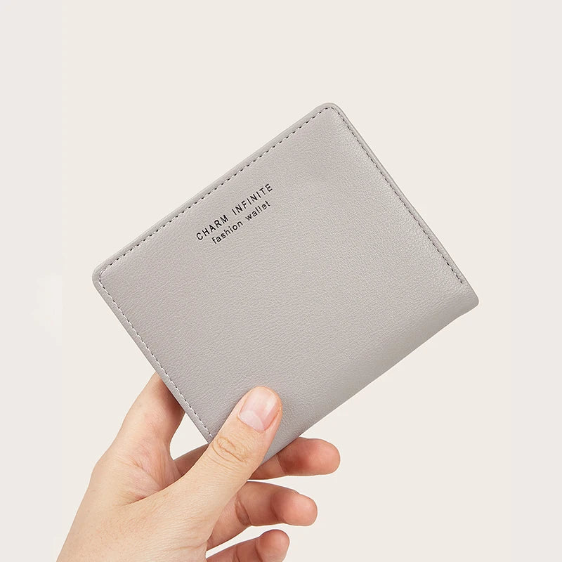 Gray wallet held by a hand