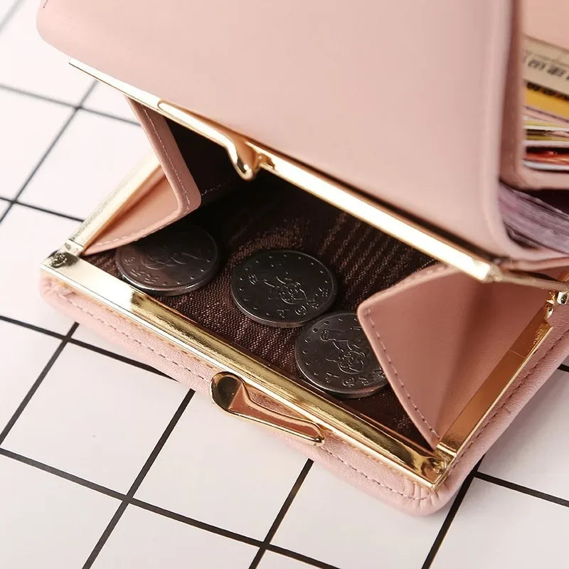 Pink and gold coin purse with coins on a grid background