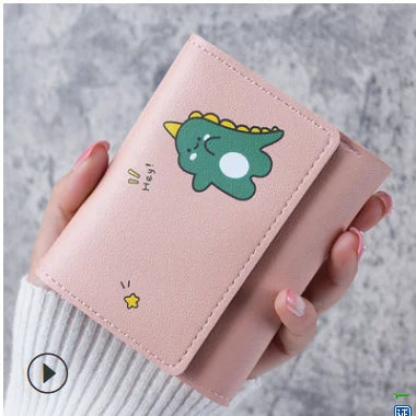 Pink wallet with a cartoon dinosaur design