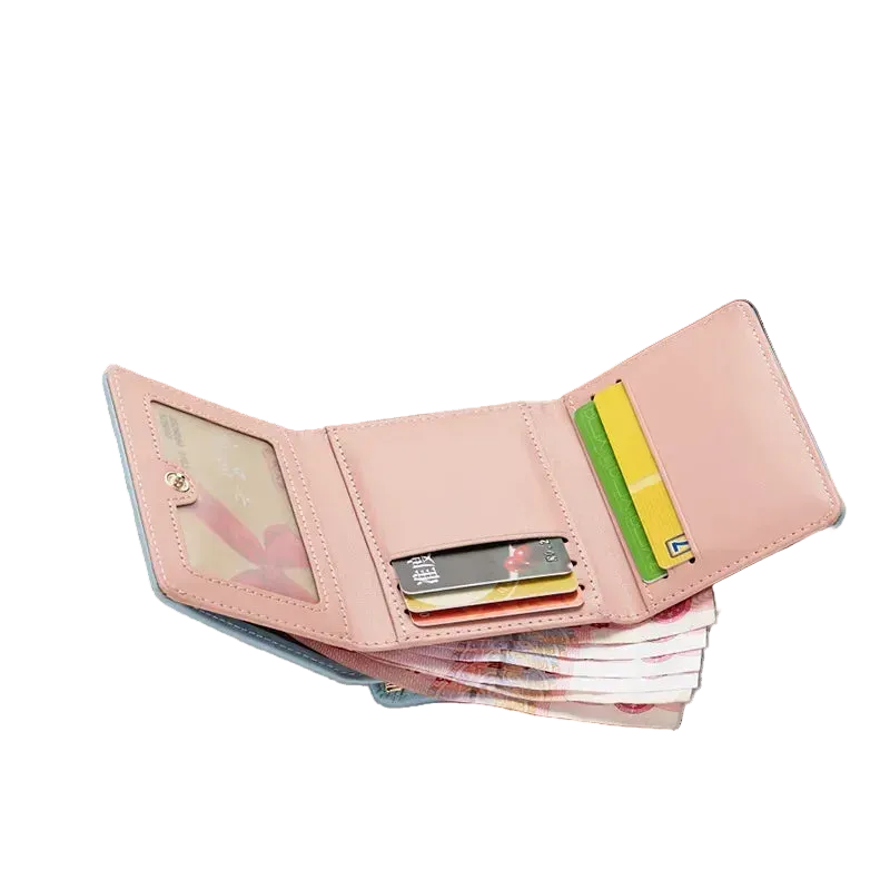 Pink wallet with cards on a magazine with sunglasses and floral design in the background