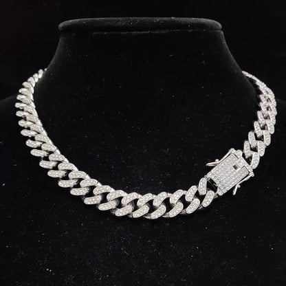 Silver chain necklace on a black velvet stand